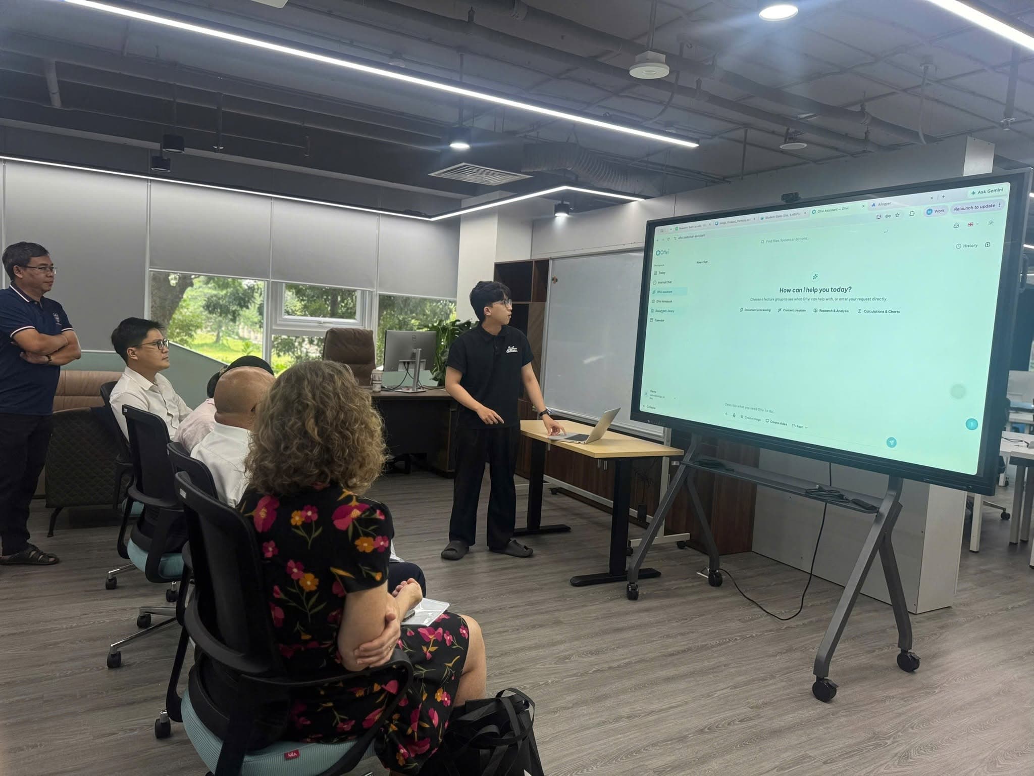 The AILOGY team demonstrates the OFIVI AI assistant interface at its Ho Chi Minh City branch.